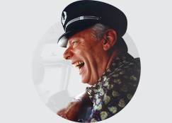 Herb Kelleher laughing, wearing Captain's hat