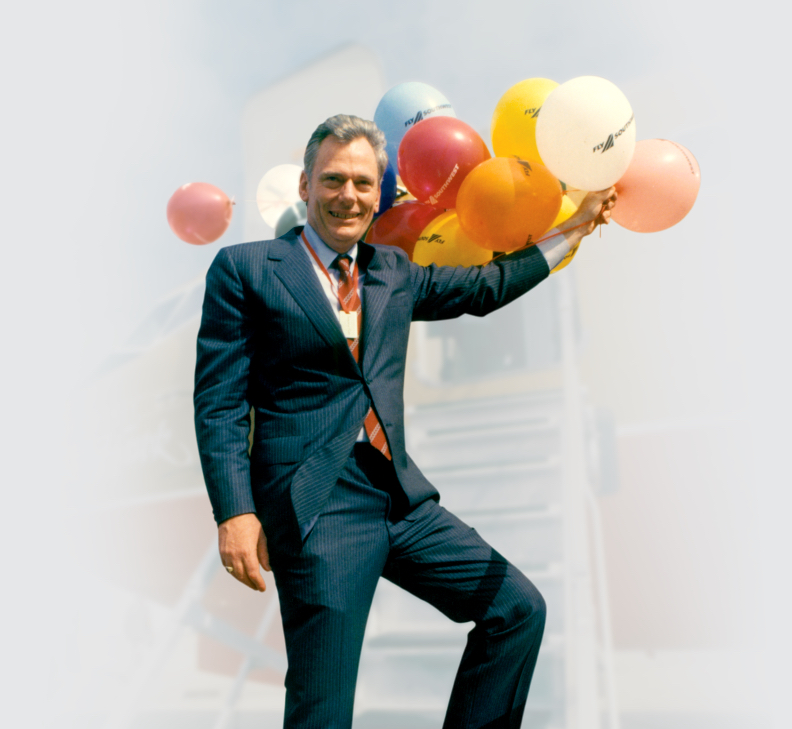 Herb Kelleher holding a large bunch of Southwest Airlines balloons
