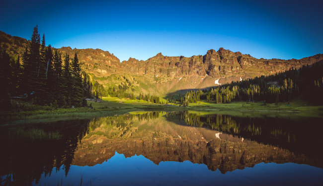 Panoramic view of Hyalite Lake with mountains and forest in Bozeman, Montana