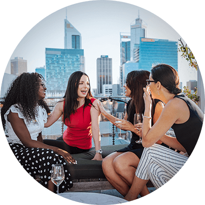 women smiling and chatting in the city